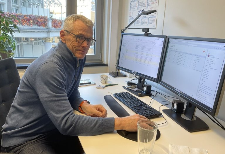 Kjetil Digre sitter på sitt kontor foran PC-skjermene sine